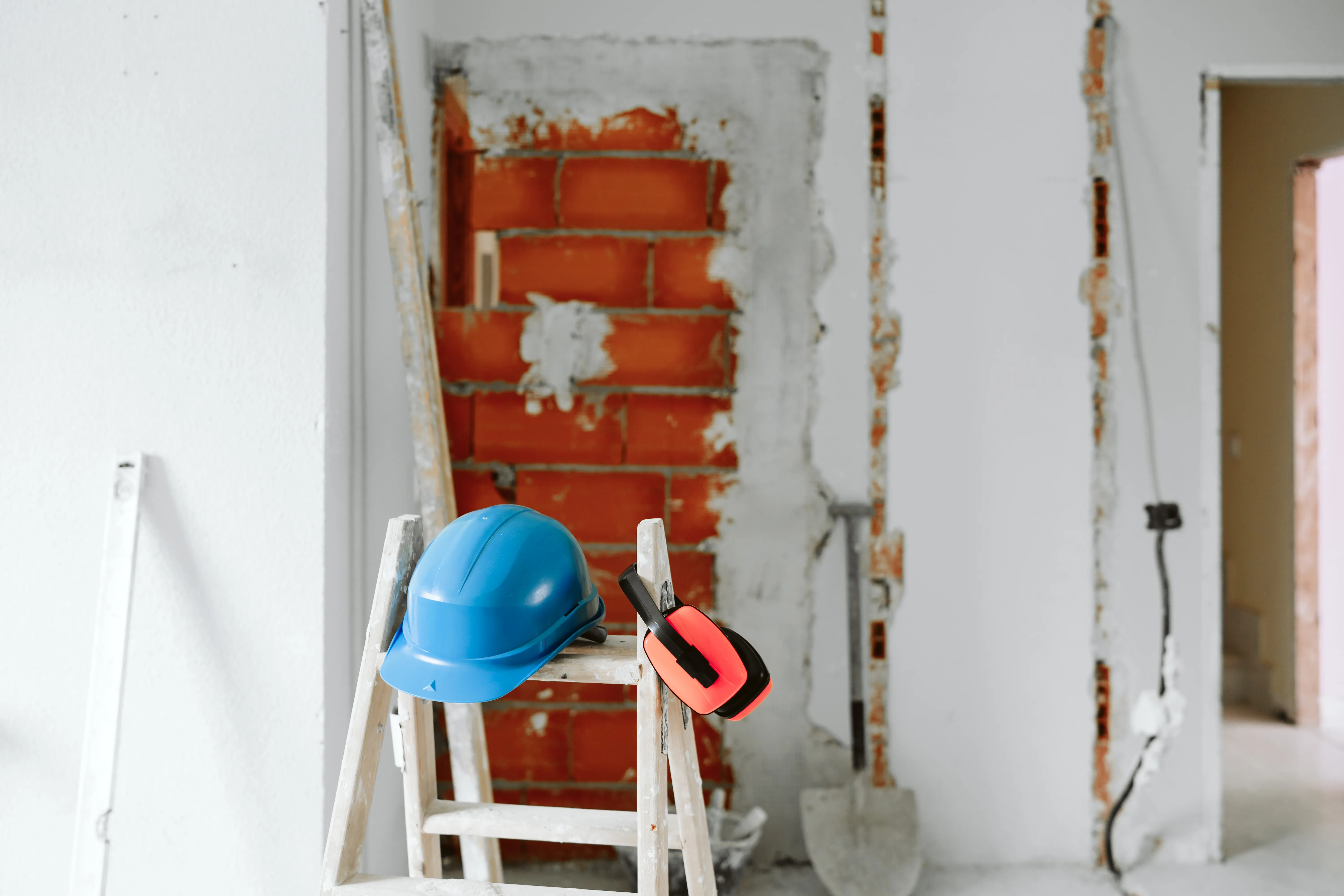 Casco e cuffie di protezione su una scala in un cantiere